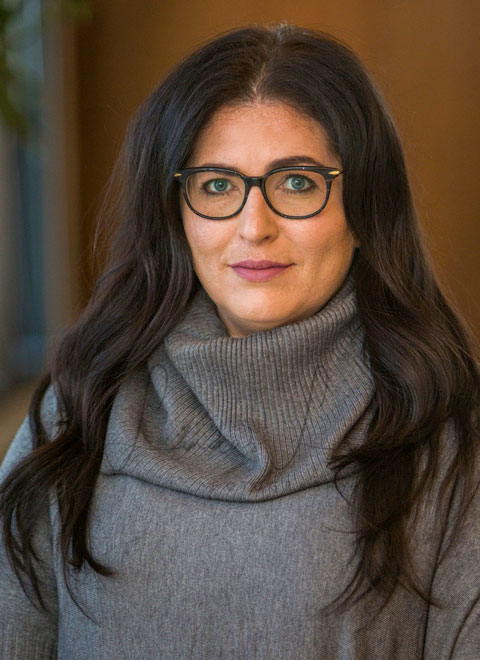 woman with glasses looking at camera